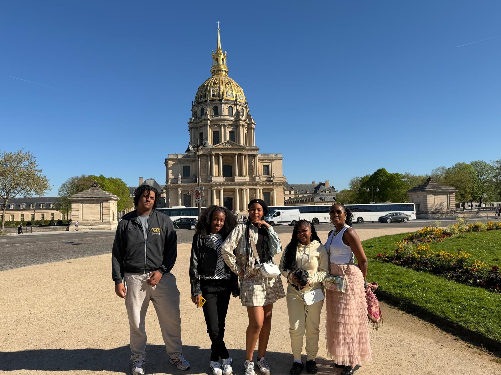 Students posing in front of Les Invalides golden dome in Paris
