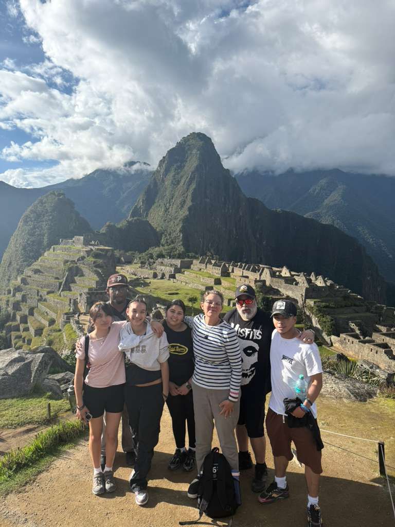 Group of students and adults posing at Machu Picchu Peru