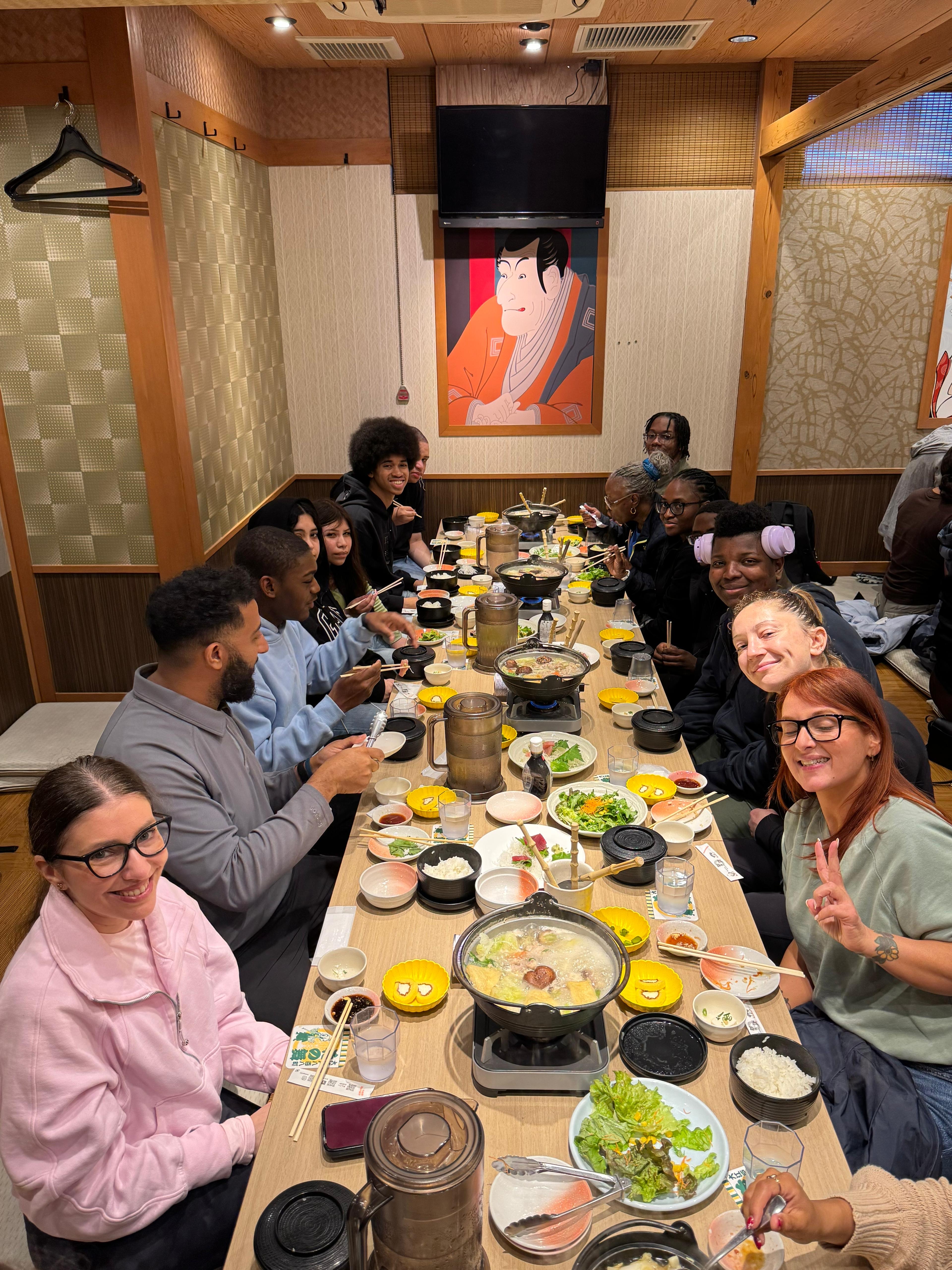 Students and chaperones sharing a Japanese hot pot meal together