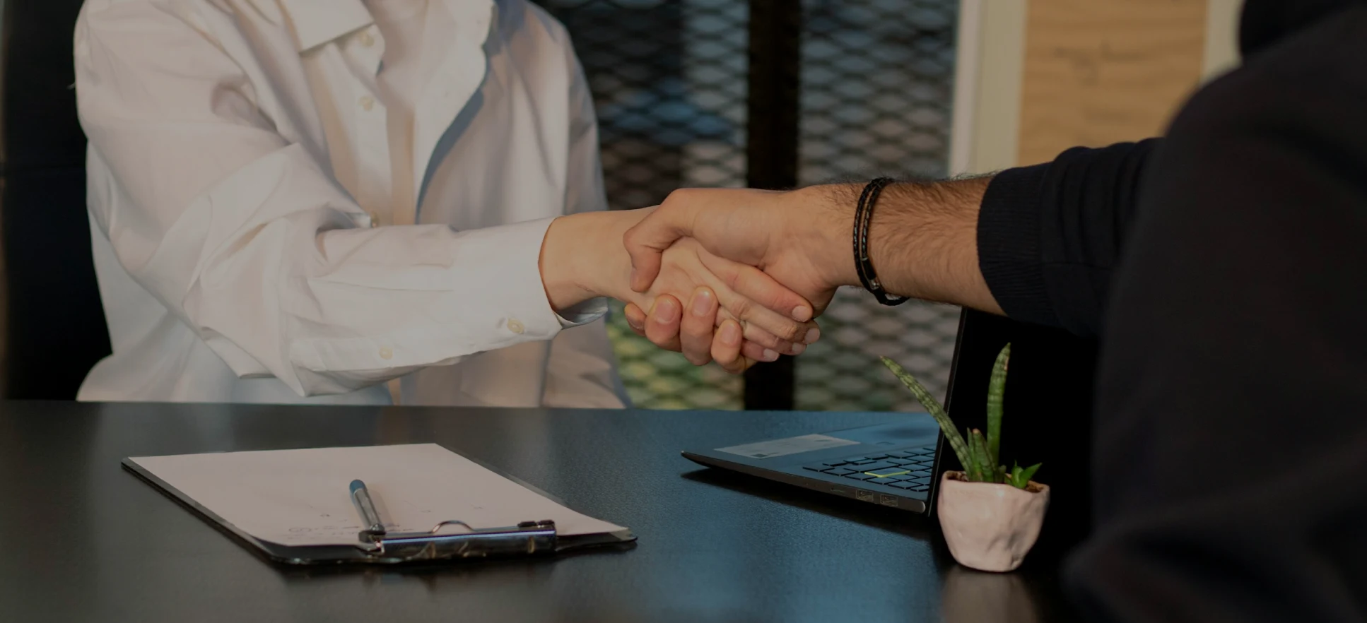 two people shaking hands in partnership