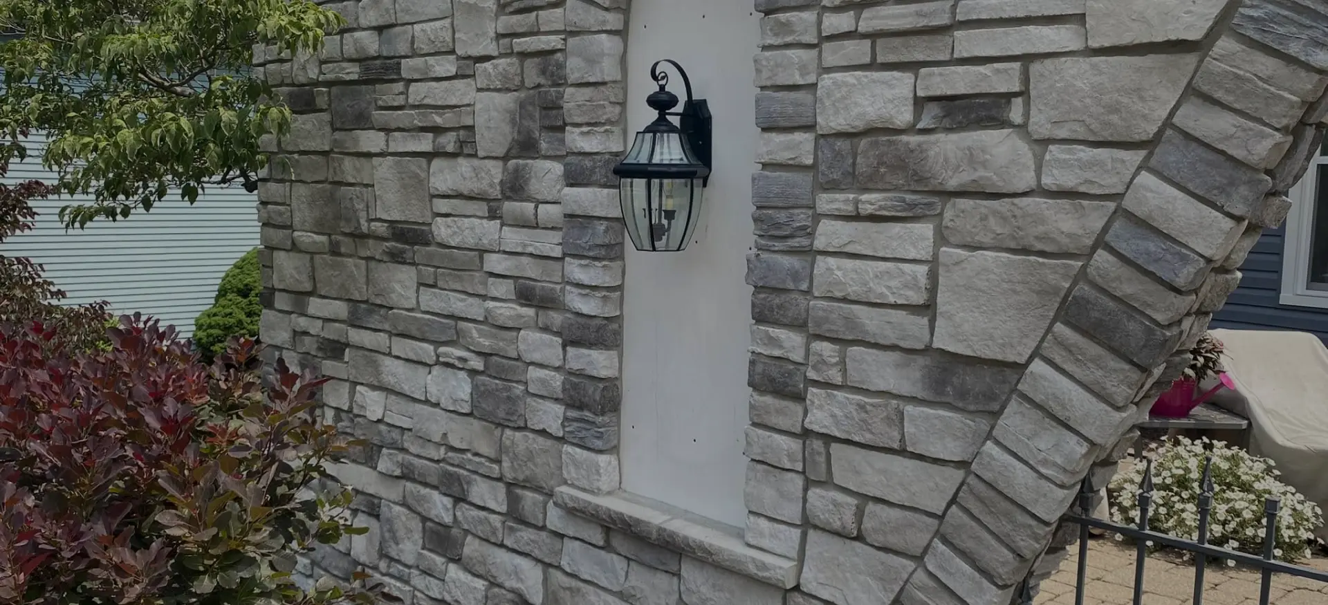 beautiful arranged stone around outdoor light fixture