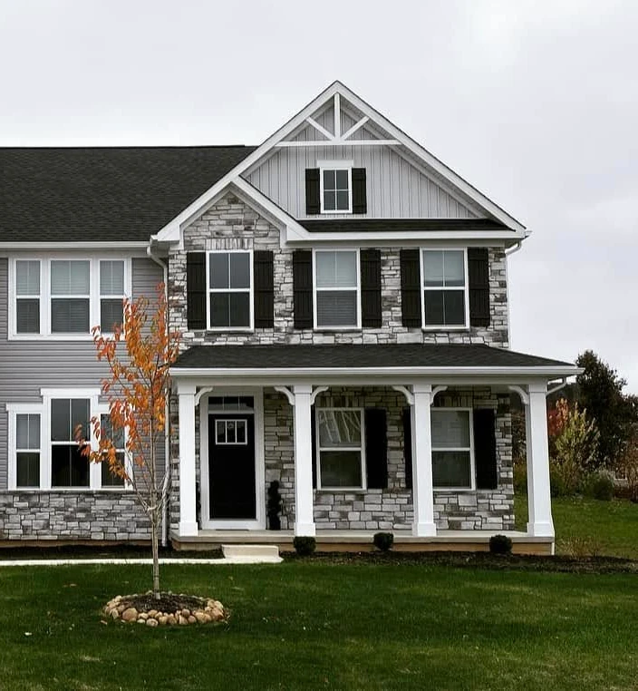 side of large home with stone siding