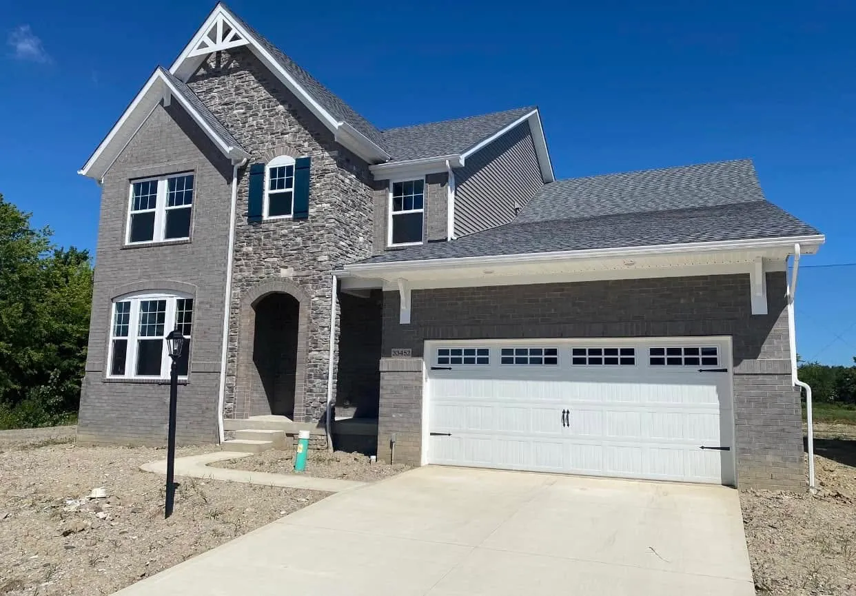 tall home with stone siding on front
