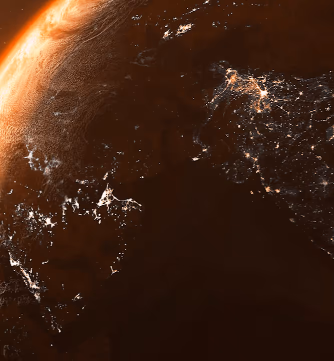 Vue spatiale de la Terre montrant les lumières des villes de nuit et un coucher de soleil partiel.