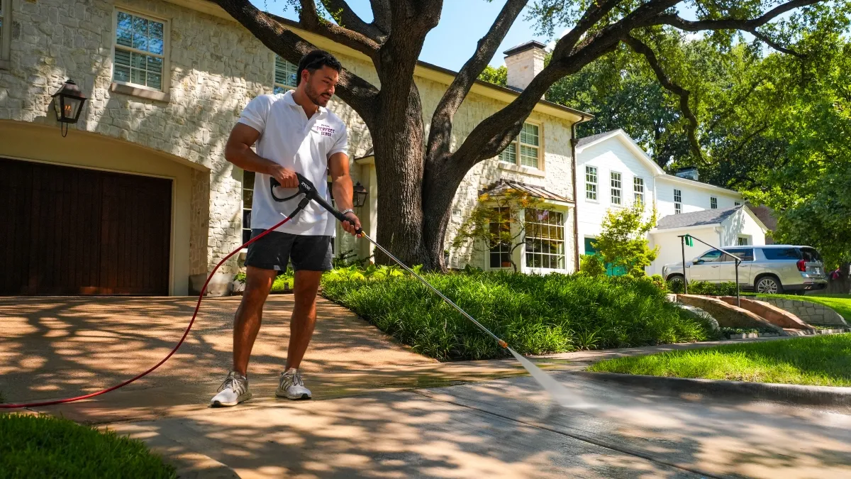 Professional pressure washing services for a residential driveway in Dallas, TX