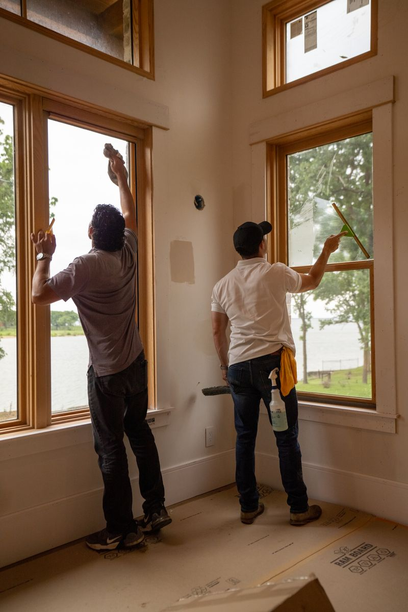 Post-construction window cleaning removing residue from newly installed interior windows