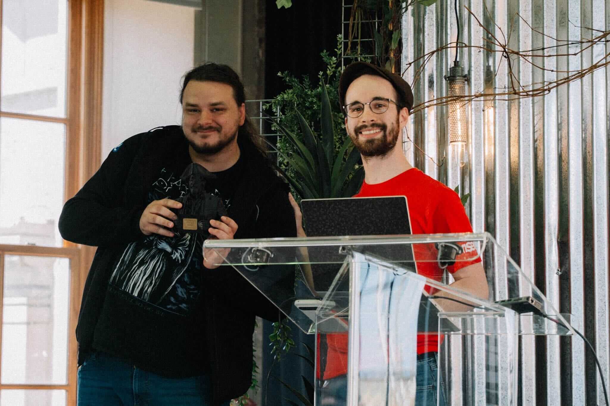 Philippe Dugre smiles at a podium while receiving the Challenge Designer of the Year award at NorthSec.