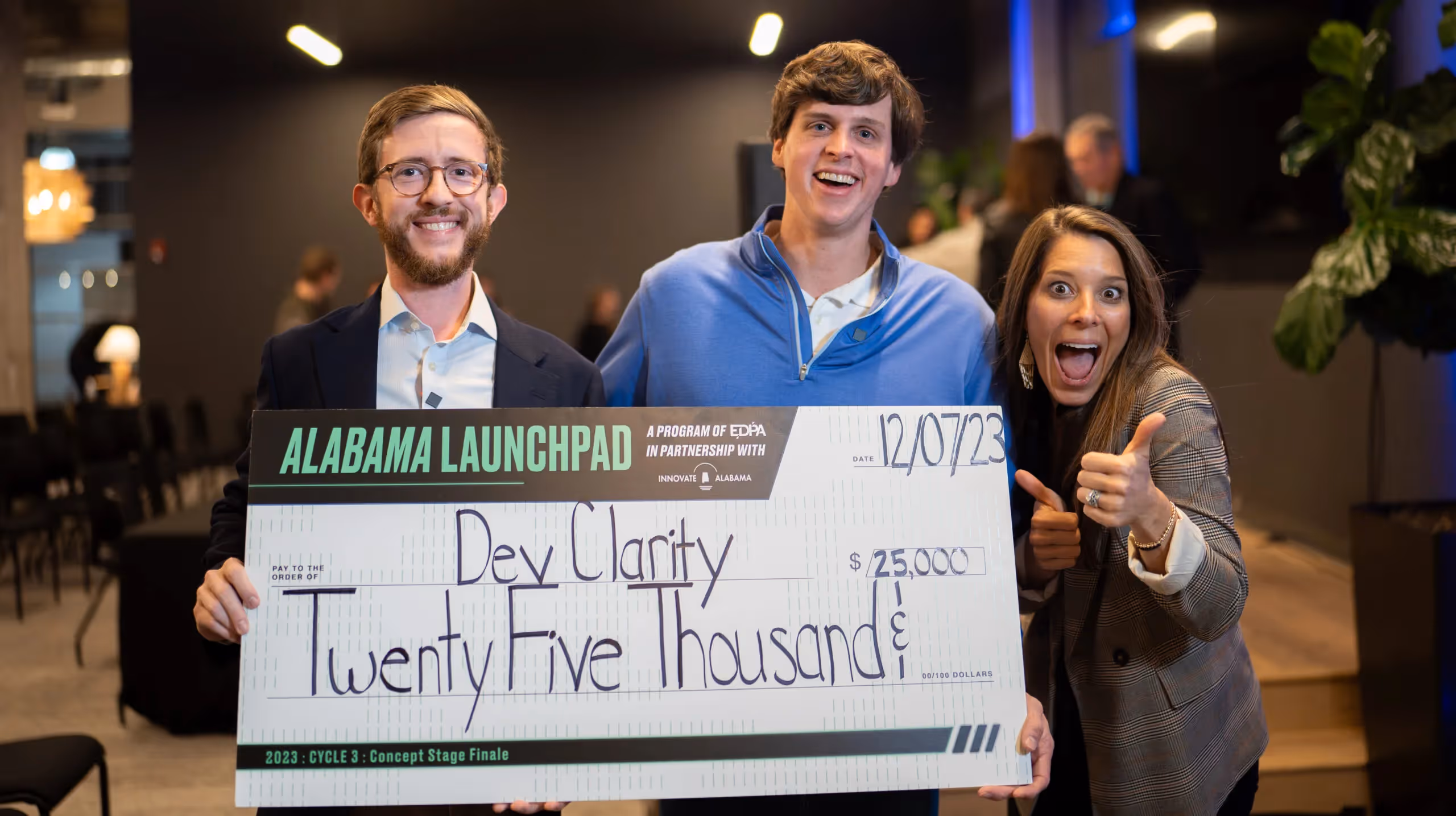 Will Blackburn, founder of DevClarity, celebrating with a $25,000 Alabama Launchpad award check