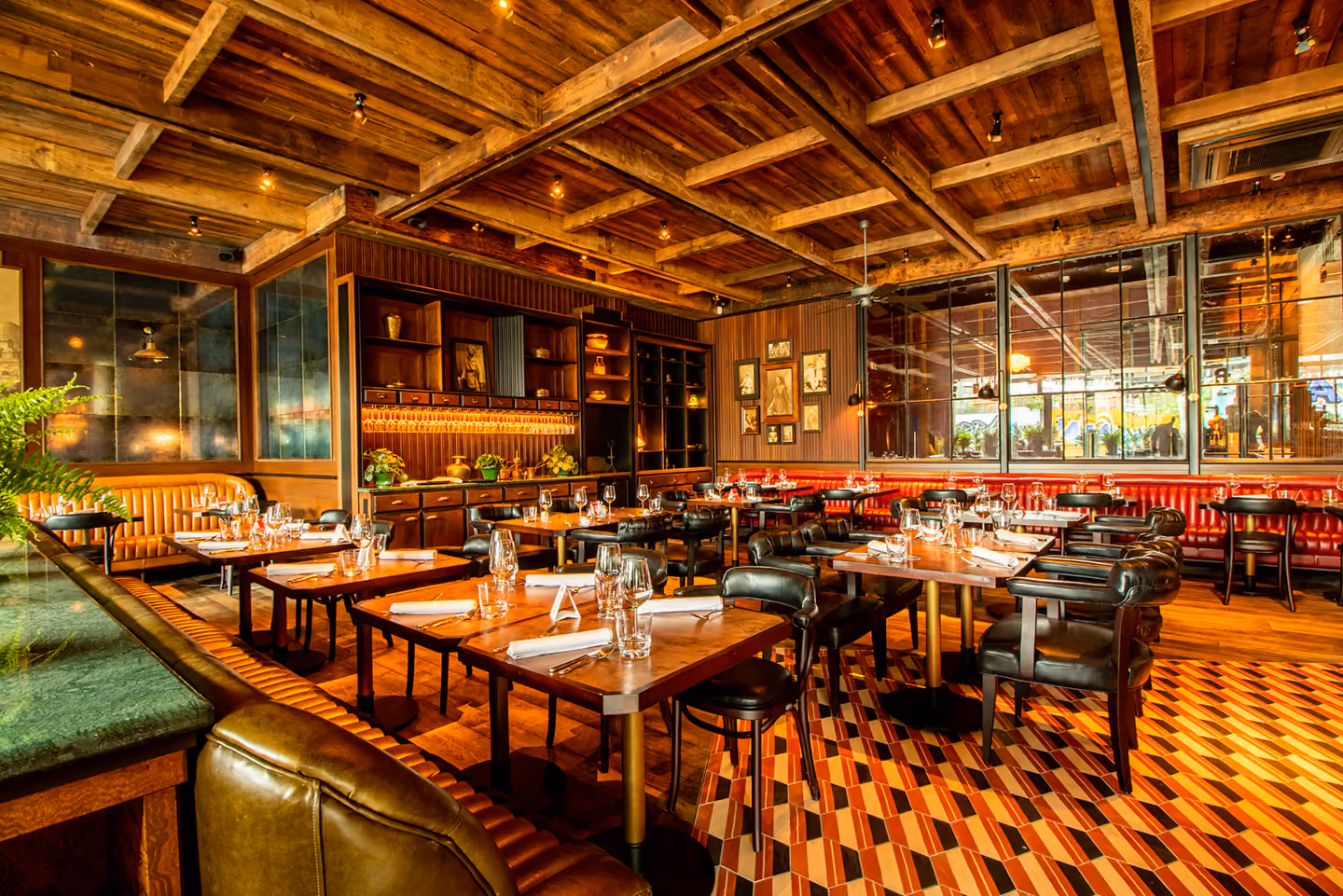 The dining room at Doolally, warm wood and glowing lamps