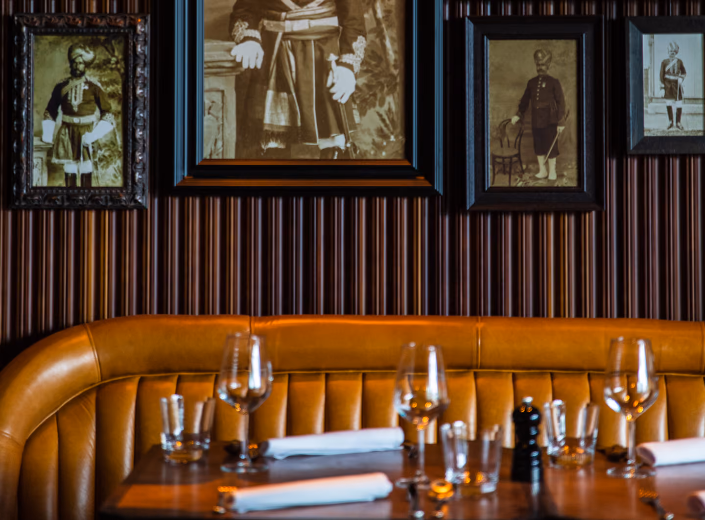 Banquette seating beneath framed pictures at Doolally