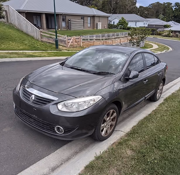 Grey sedan parked on the side of a residential road.