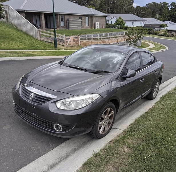 Grey sedan parked on the side of a residential road.