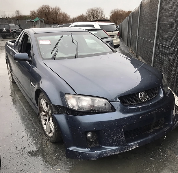 Old vehicle with visible damage prepared for scrap car collection.