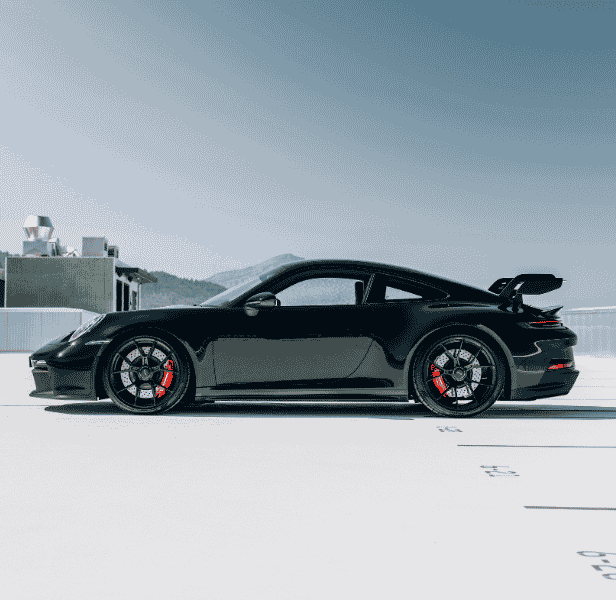 Side of Porsche vehicle.