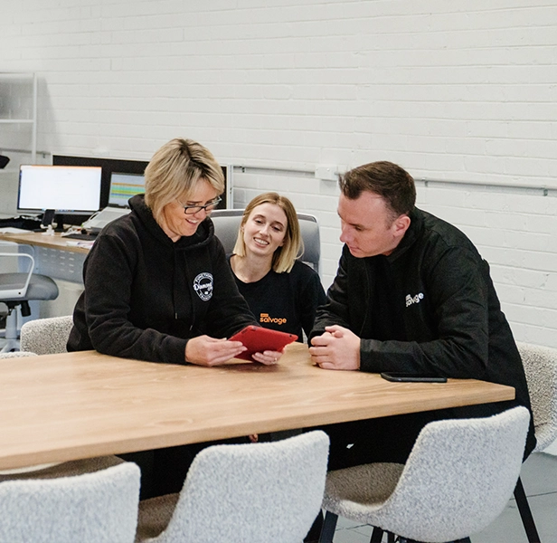 Team reviewing vehicle details together in a modern office.