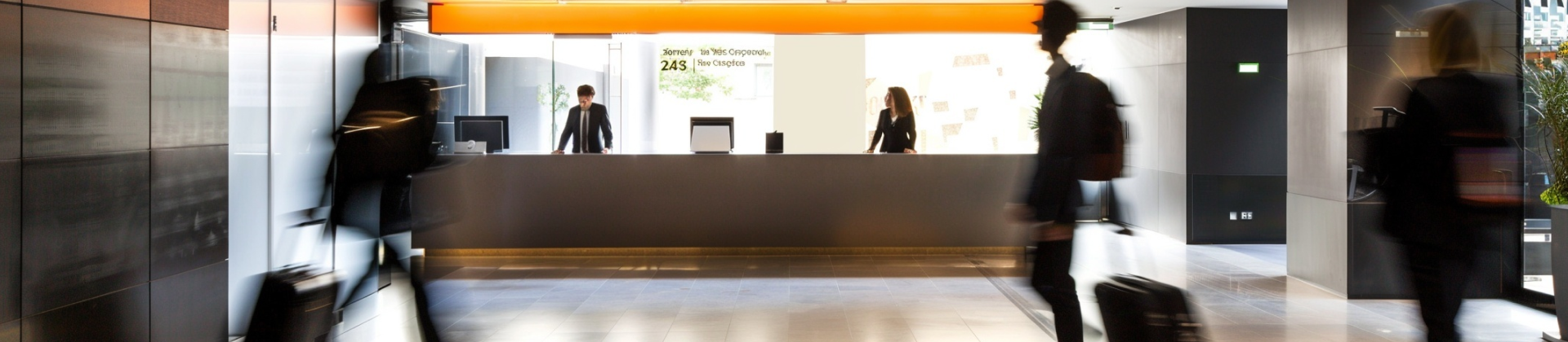 Modern clothing store interior with shelves and racks of neatly arranged garments and blurred shoppers walking.