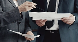Two men reviewing paperwork.