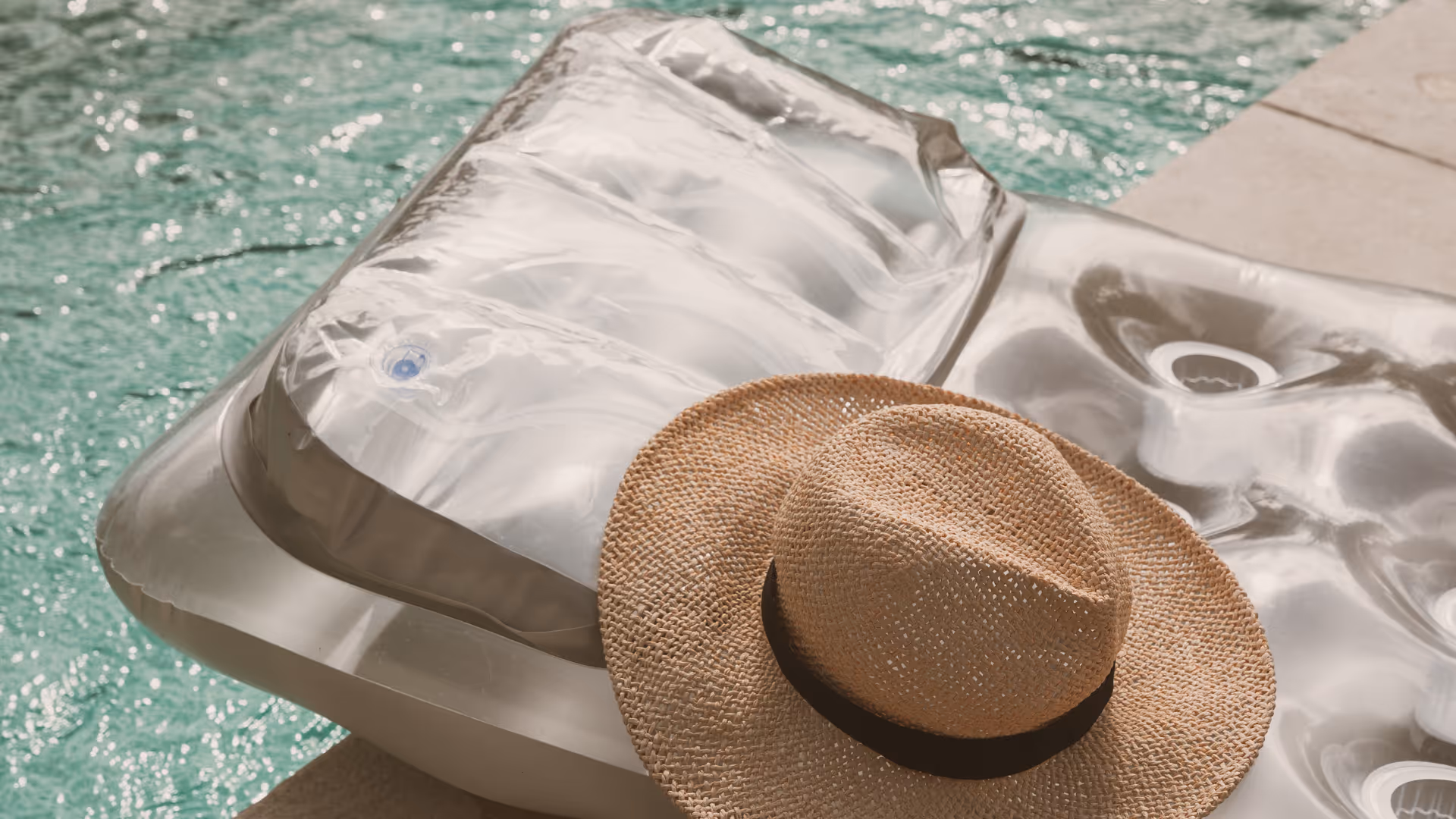 Hat and lounging floatation device next to pool