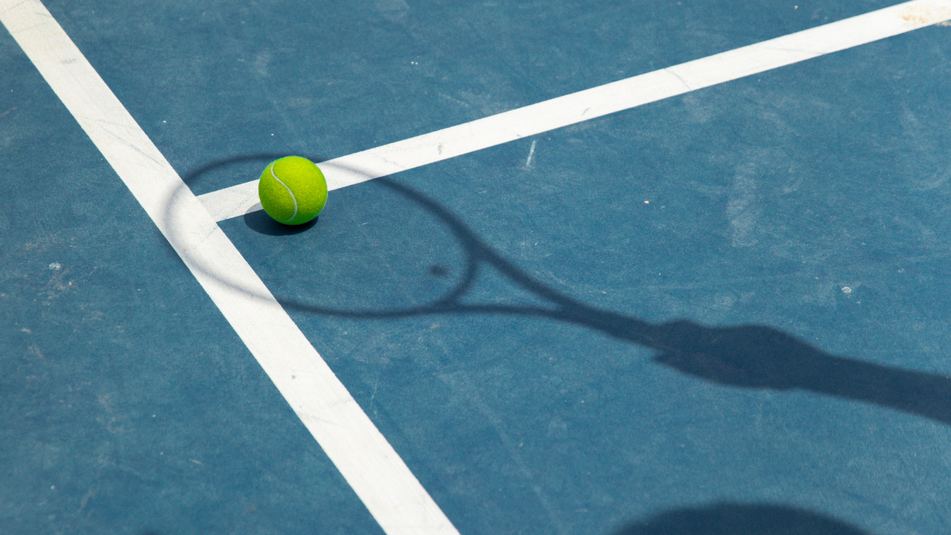 Tennis court with male shadow holding racket stock image