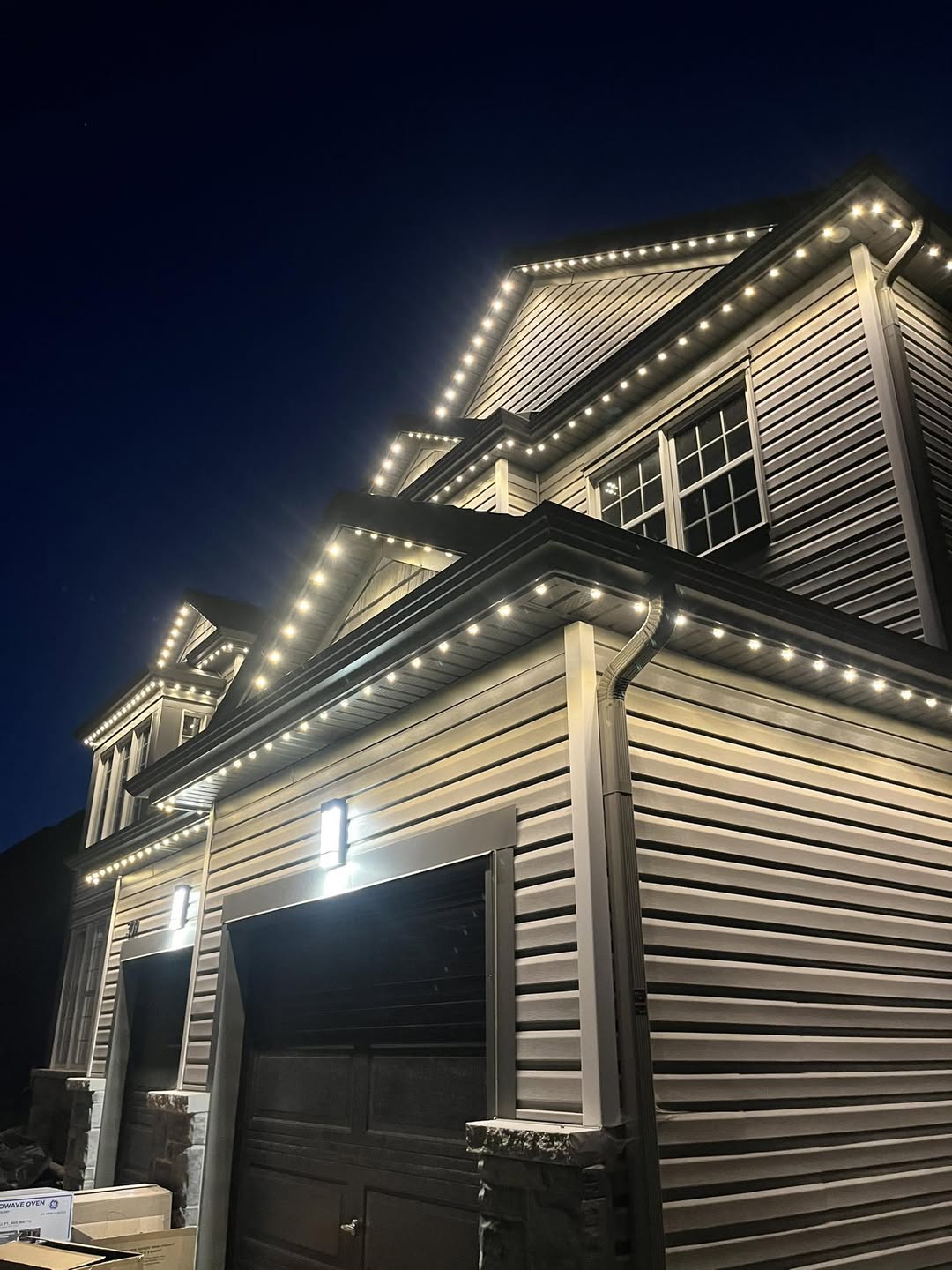 Warm white permanent LED soffit lighting installed on modern home exterior by Royal Shine Lighting in the Greater Toronto Area, showcasing clean roofline lighting for Christmas and year-round outdoor use at night