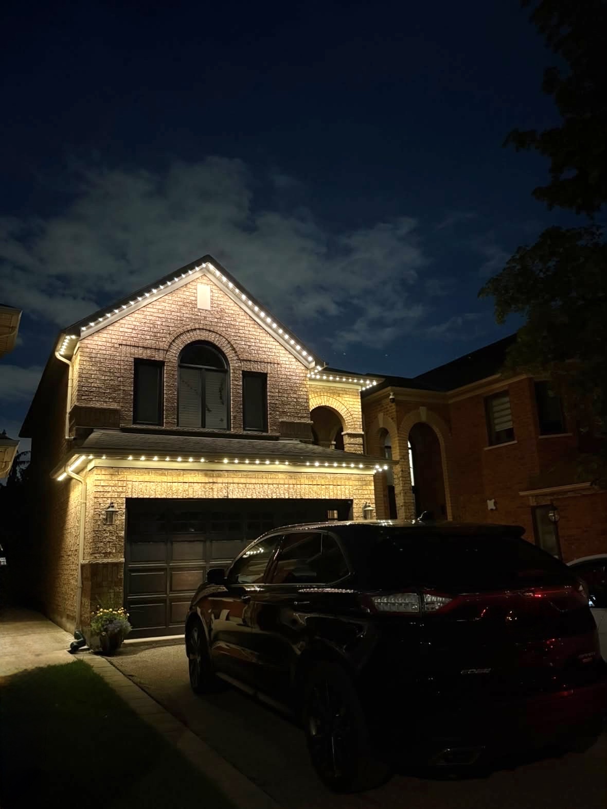 Red permanent LED soffit lighting installed on modern two-storey home by RoyalShine Lighting in the Greater Toronto Area, showcasing custom exterior LED lighting for Christmas and year-round use at night