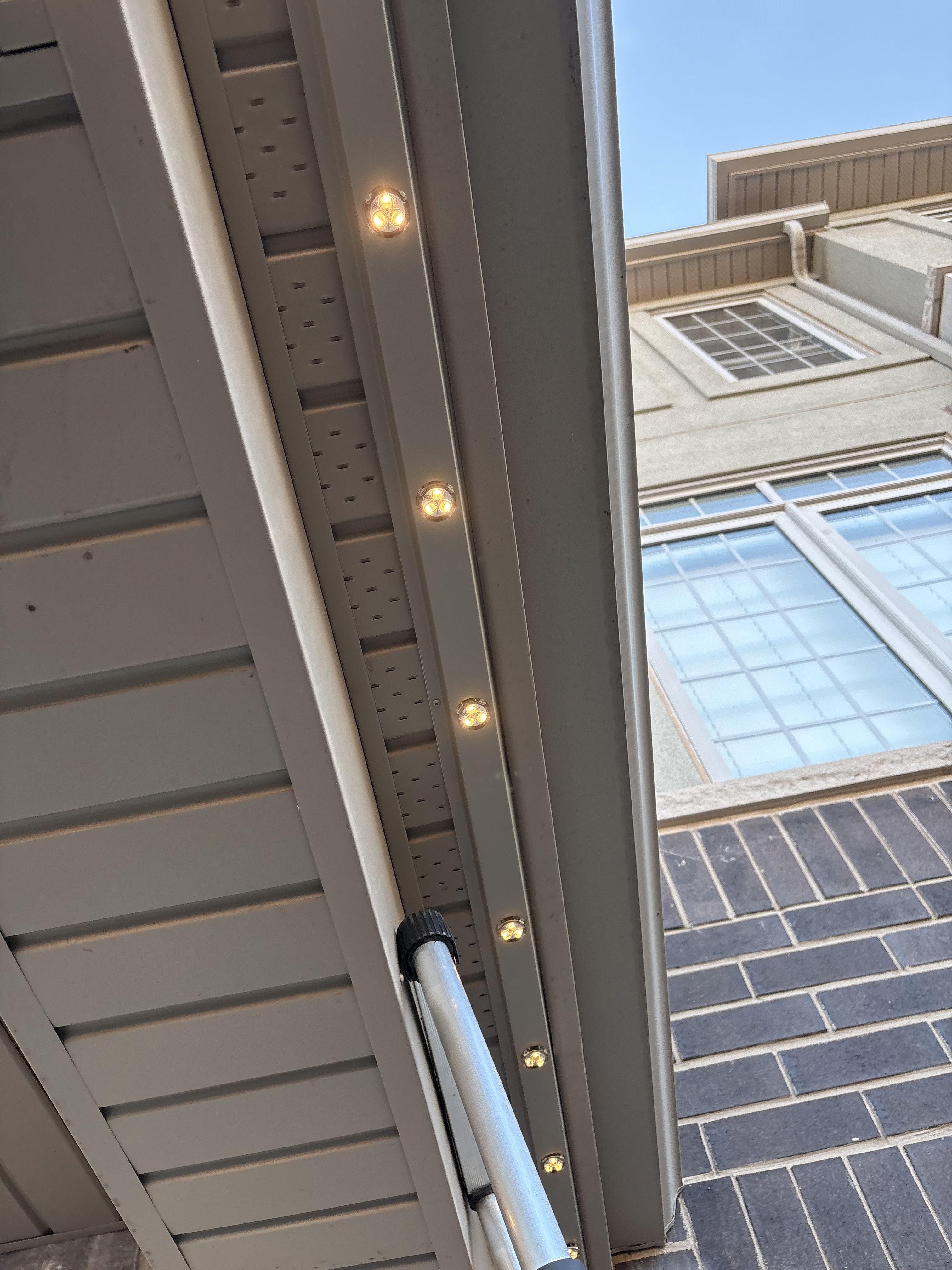 Close-up of permanent LED modules seated inside colour-matched soffit track