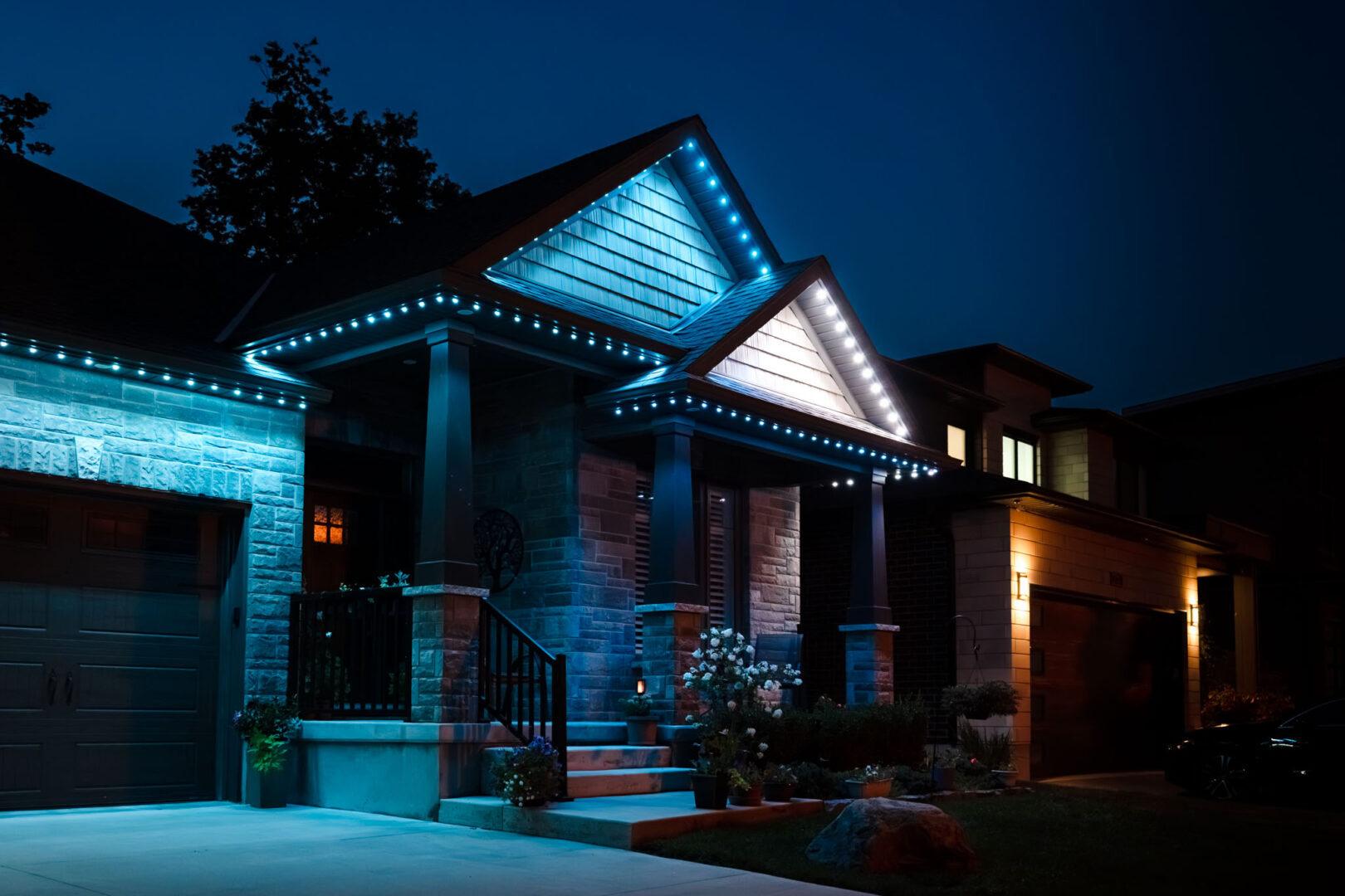 Blue permanent lighting on a stone bungalow at dusk