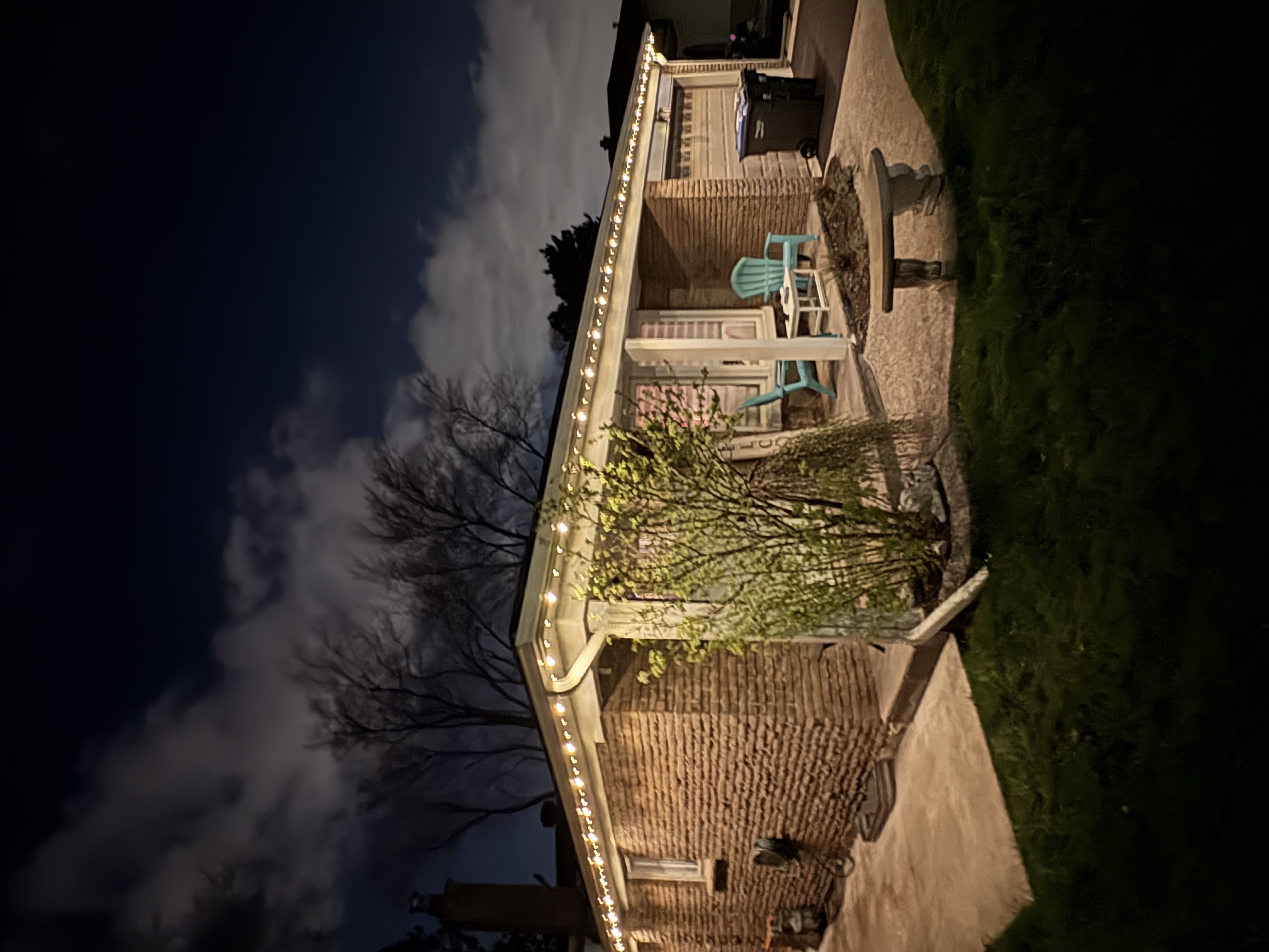 Warm white permanent lighting on a single-storey brick home