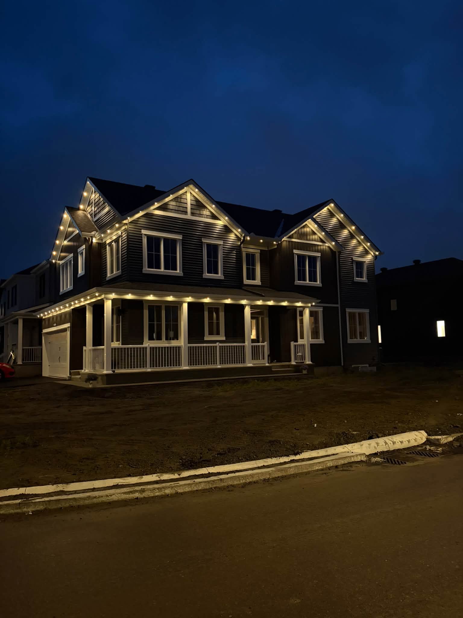 Warm white permanent lighting creating a clean pot-light style effect on a large two-storey home