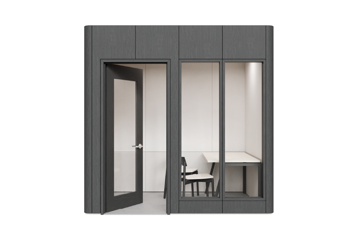A Quiet Room with black laminate exterior linings, and savoye PET interior linings. A desk is against the right wall, with two chairs, with the door open on the left.