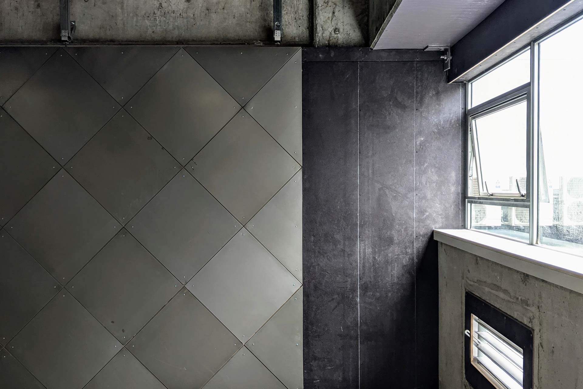 A close up of the steel diamond lining wall.