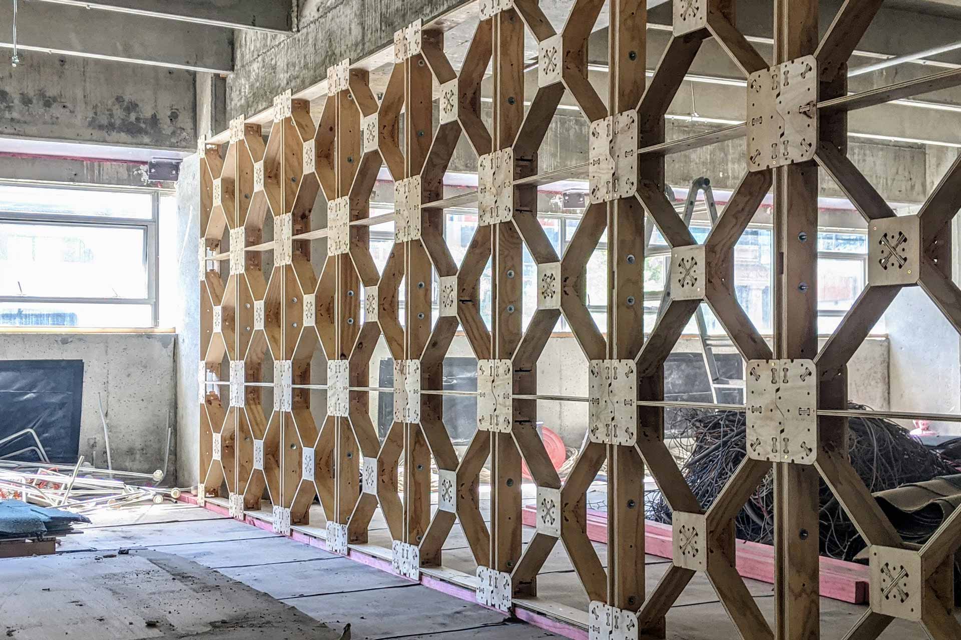 A long line of bare XFrame panels dividing a large room.