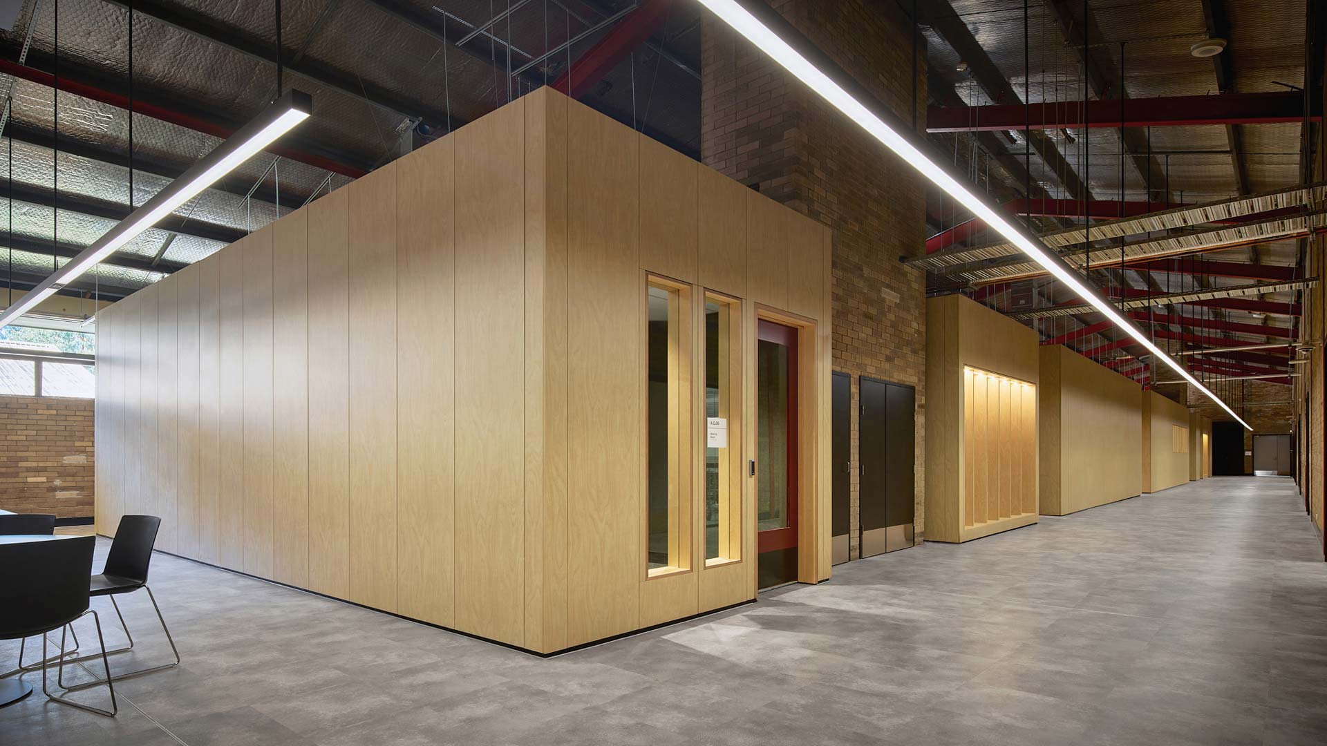 Wide angle of TAFE Padstow rooms and hall way with tasmian oak exterior lining and grey lino flooring.