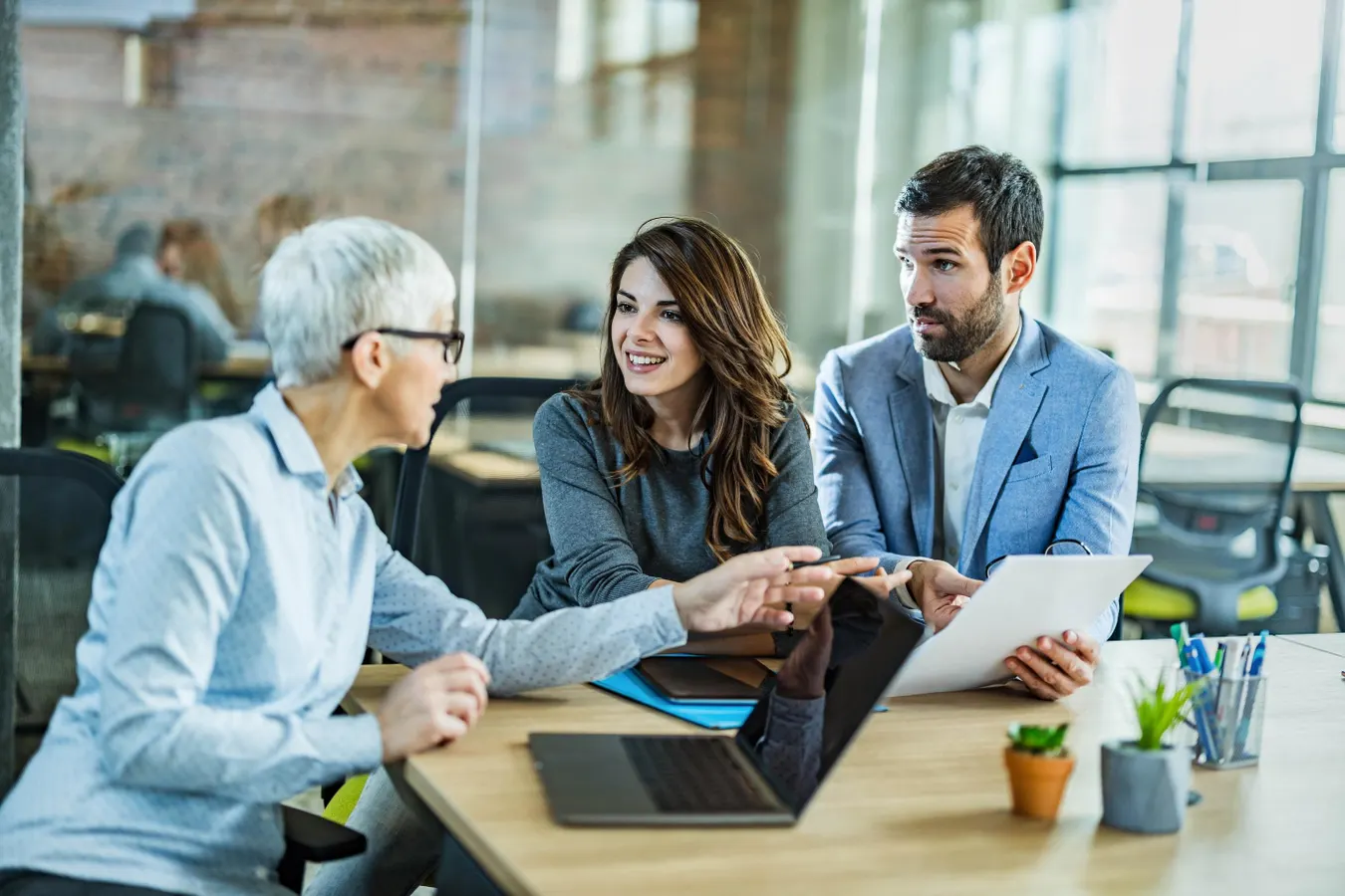 Property managers discussing AI in property management strategies around a conference table