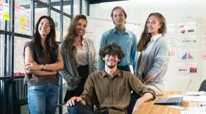 Team of professionals collaborating in a modern office environment, reflecting ManageCasa’s commitment to strong teamwork and customer support.