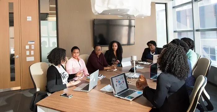 Property management team collaborating during a conference room meeting, showcasing organized communication and efficient workflow supported by ManageCasa.