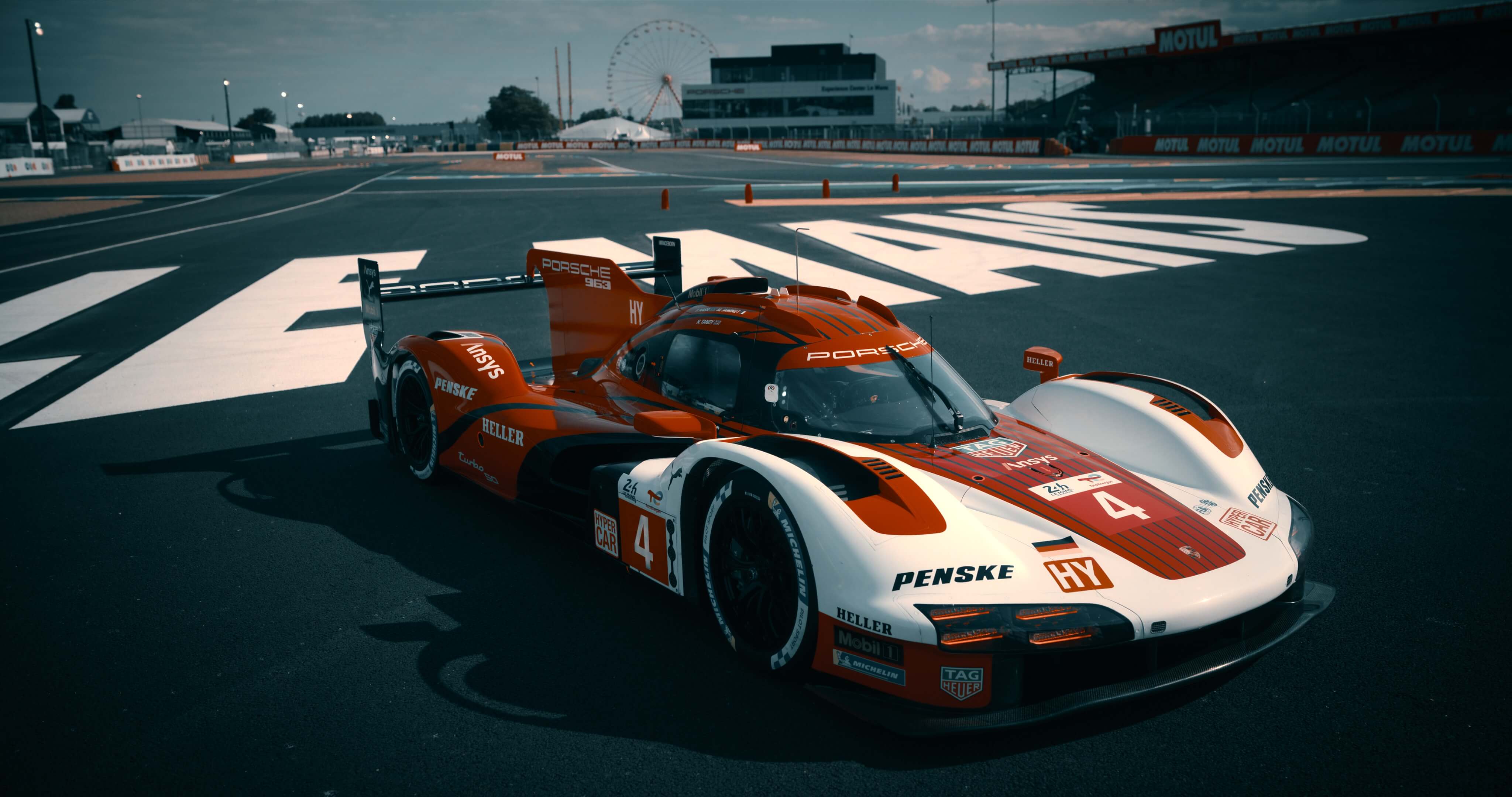 Red and white Porsche 963 race car on Le Mans racetrack with grandstands - 2DIE4 Film