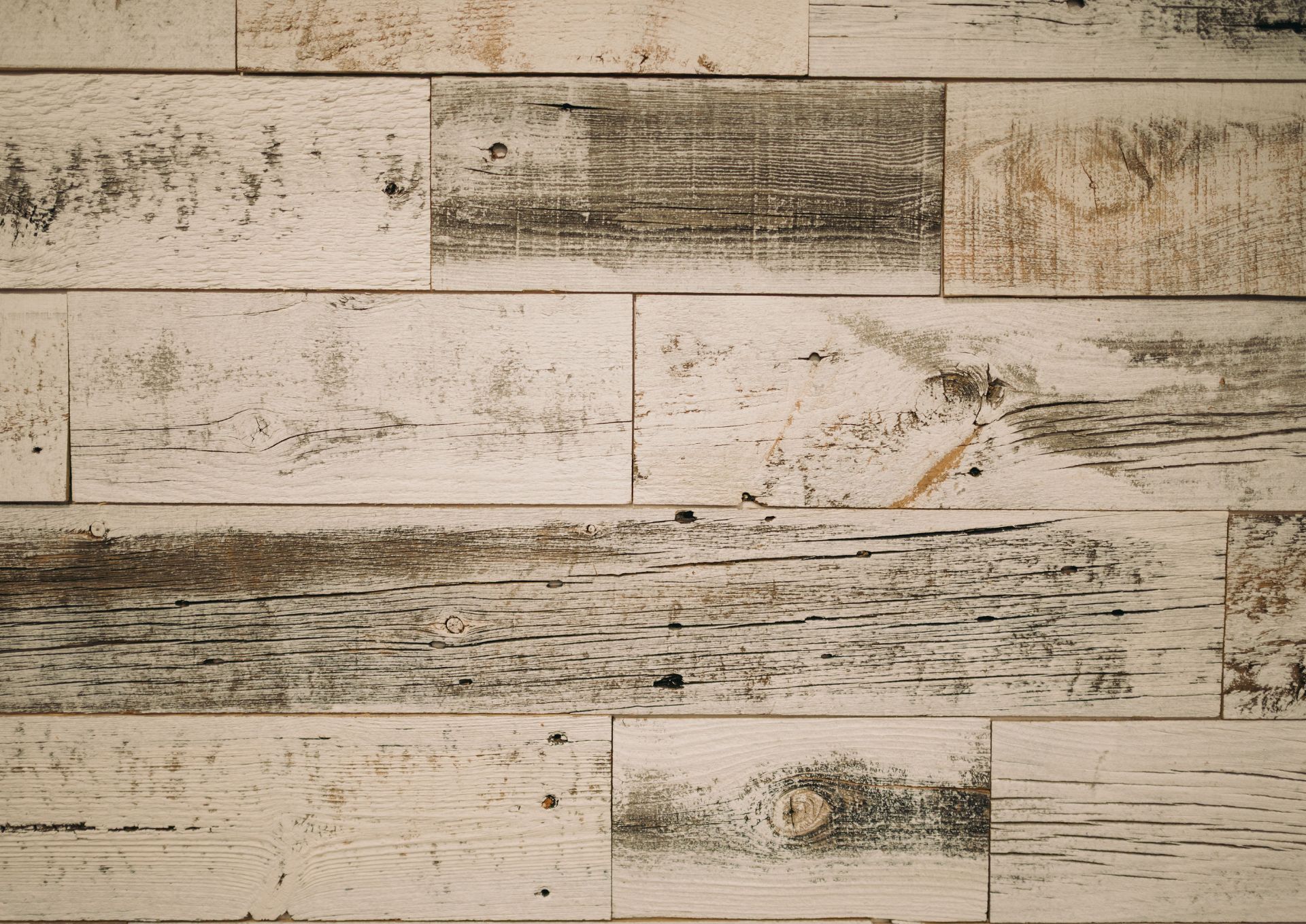 Close-up of weathered wood panels with peeling paint and visible grain texture.