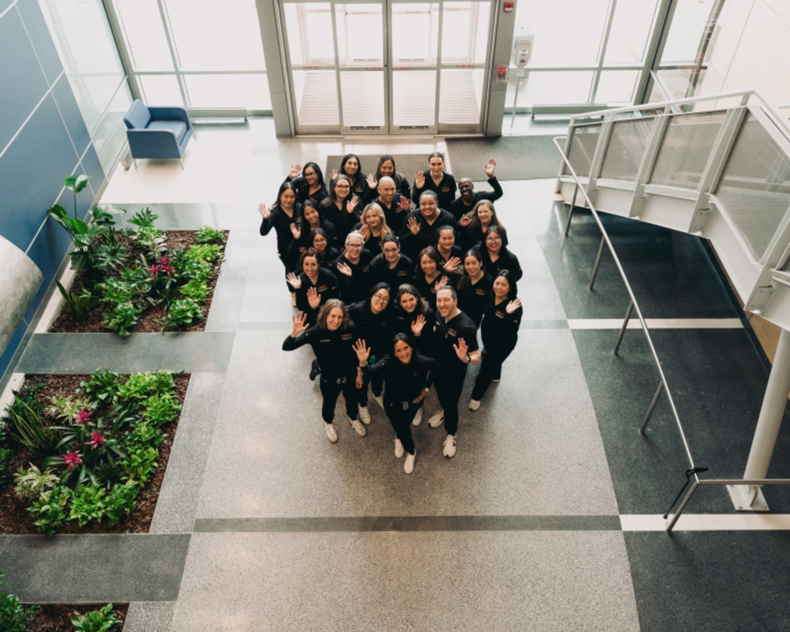 Team photo of Nova Pediatric Dentistry staff in modern office interior