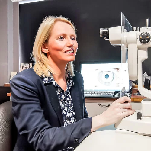 Eilish operating an eye examination machine in an optometry clinic.