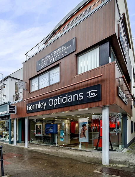 Corner building with Gormley Opticians ground-floor storefront and Barron O'Donnell Solicitors office above.