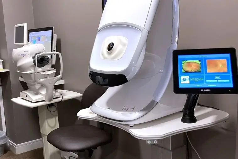 Optometry exam room with advanced eye test equipment including an Optos retinal scanner and a digital eye examination machine.