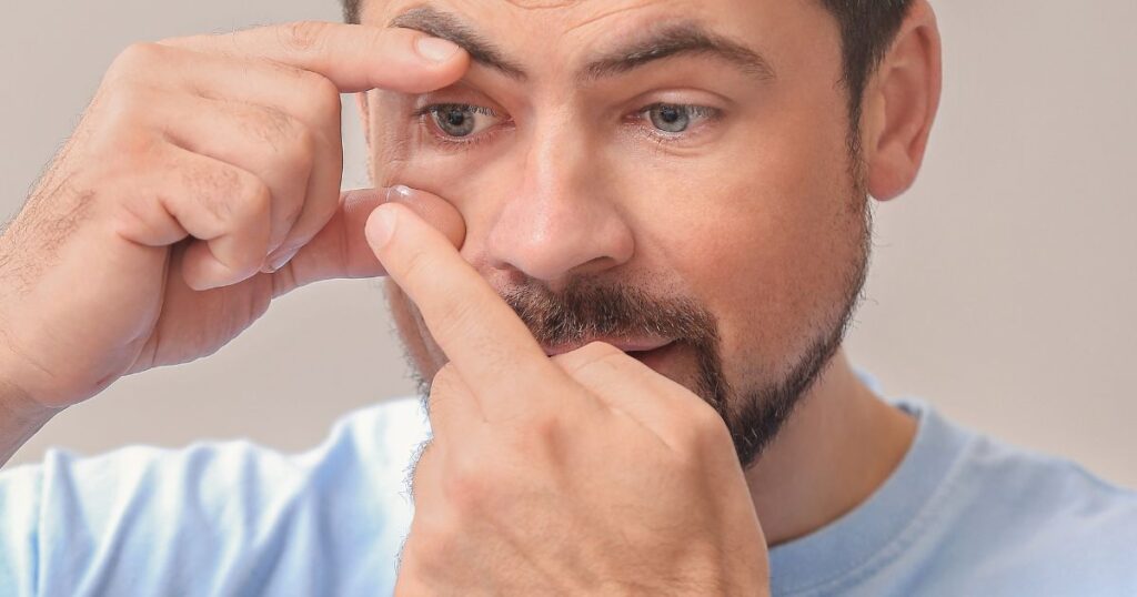 man applying contacts