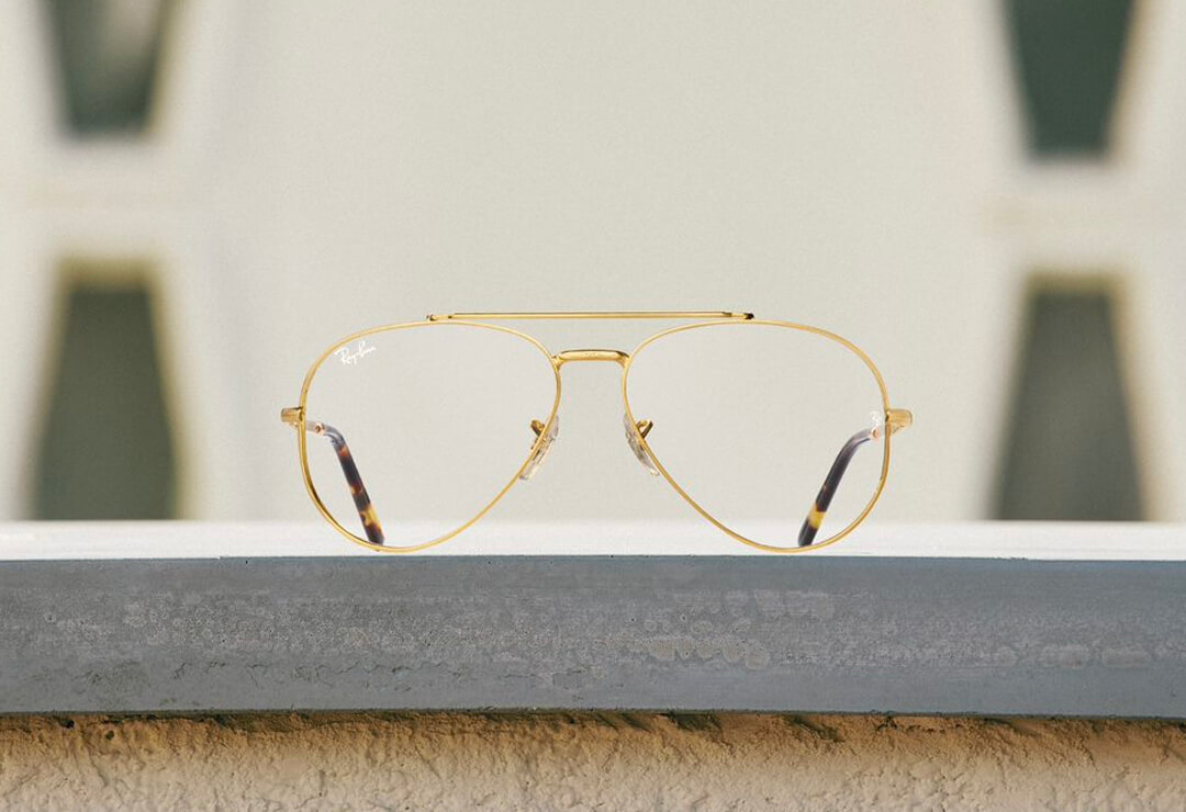 Classic gold aviator Ray-Ban glasses on display shelf.