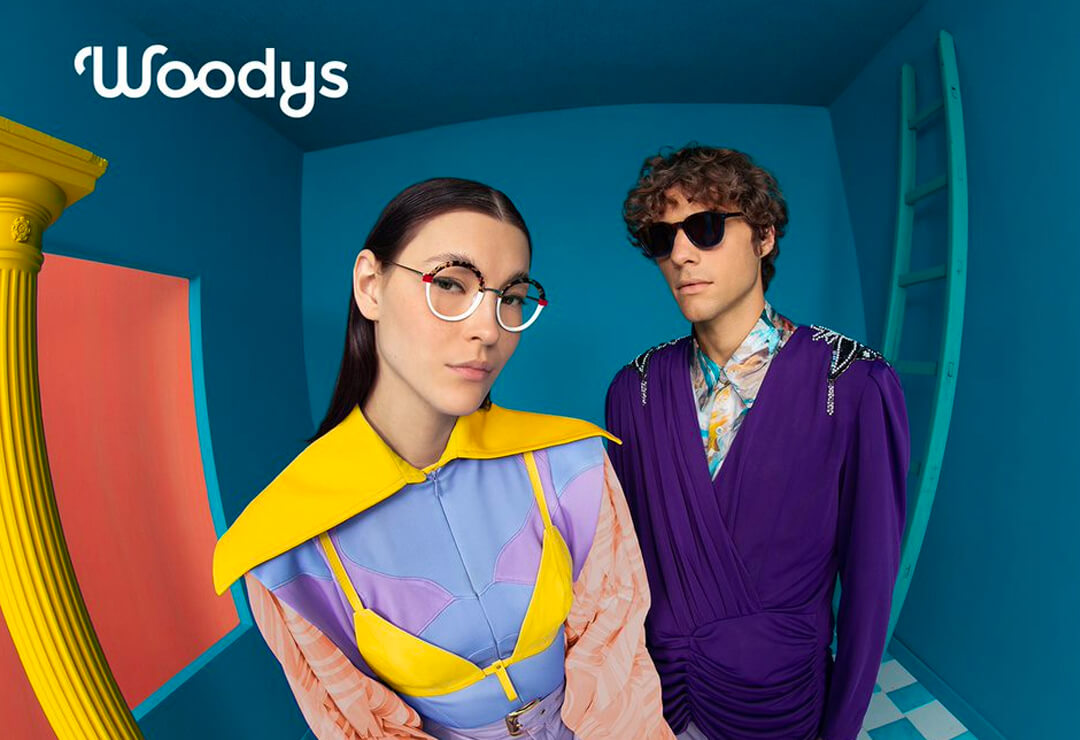 Woman wearing Woodys glasses in a vibrant colourful setting.