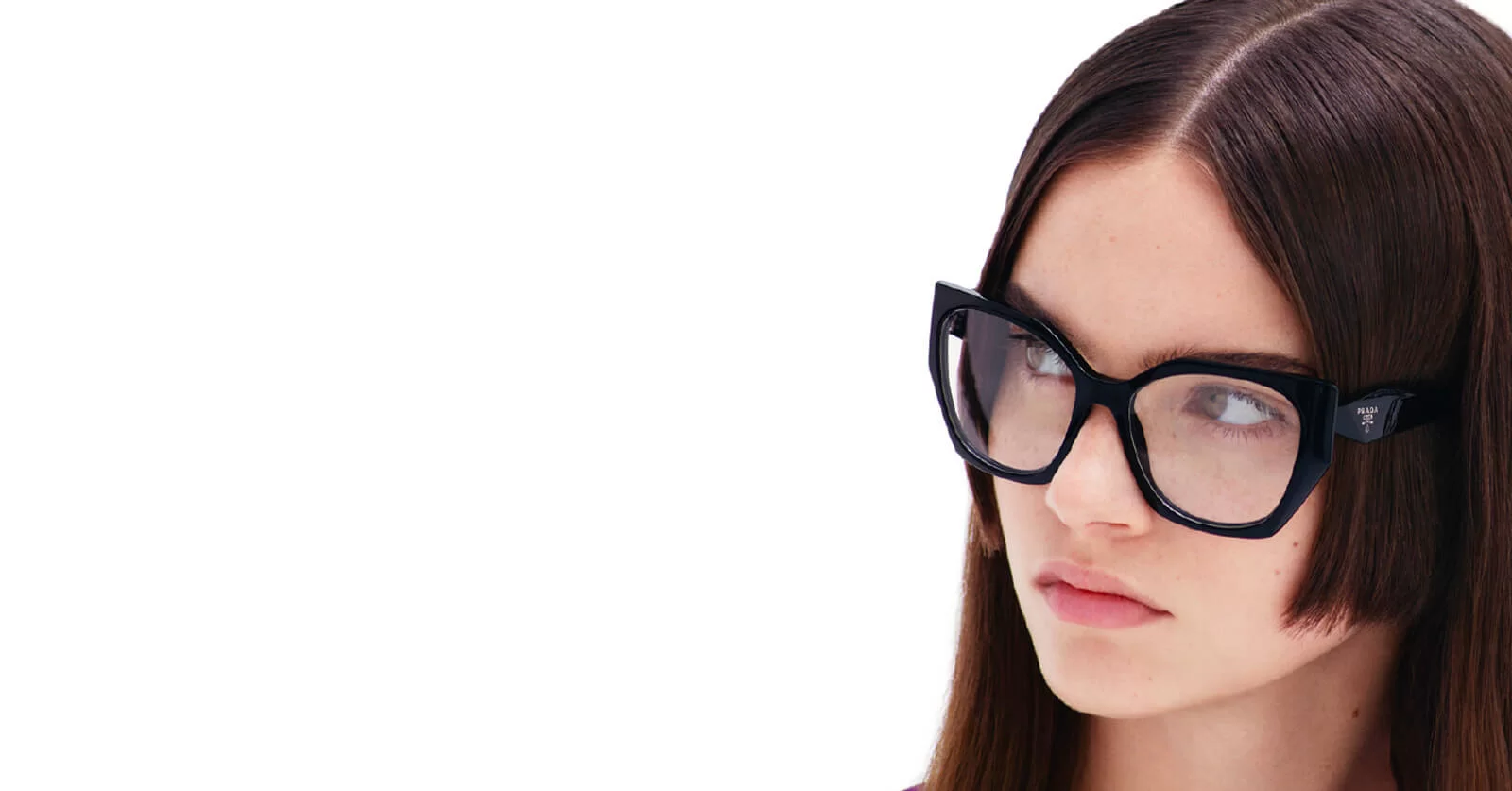 Woman wearing oversized black Prada cat-eye glasses frames.