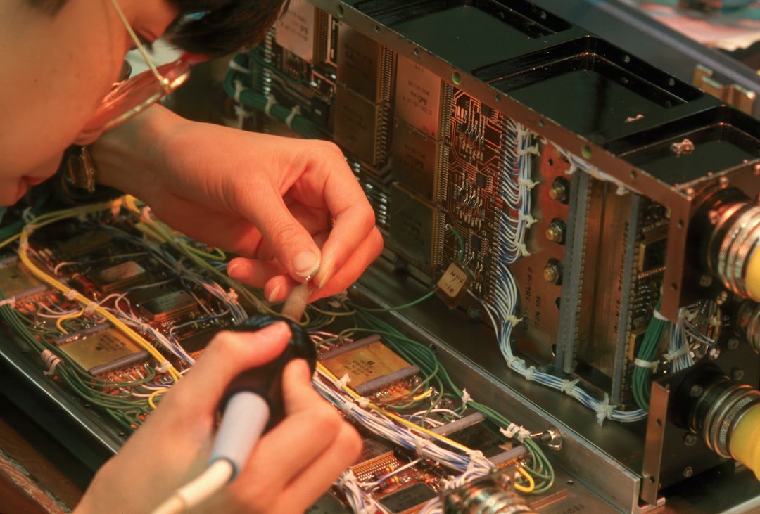 HVAC technician inspecting complex wiring for a smart thermostat installation - smart thermostat installation affordable in