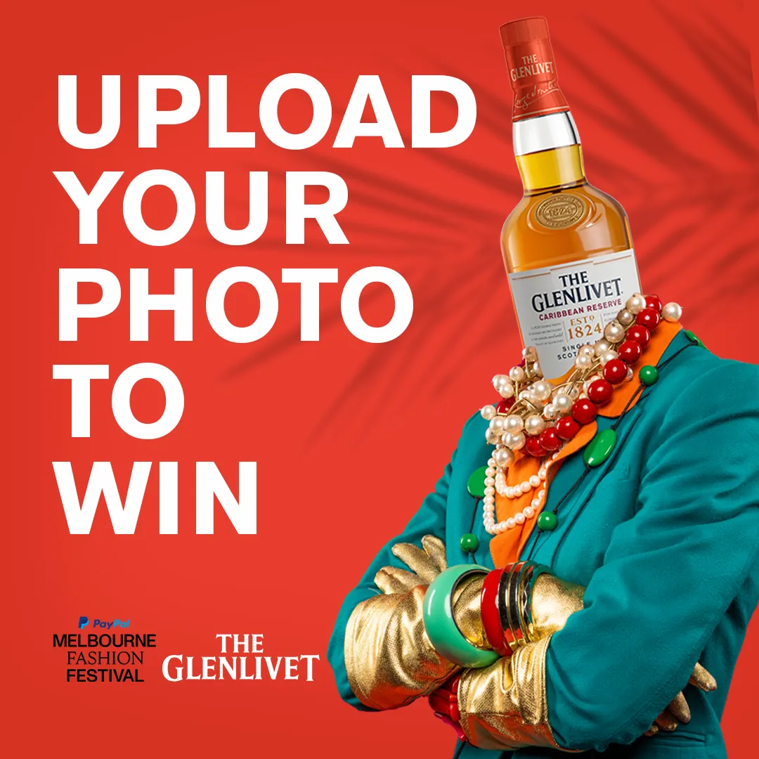 A man with a bottle of alcohol on his head.