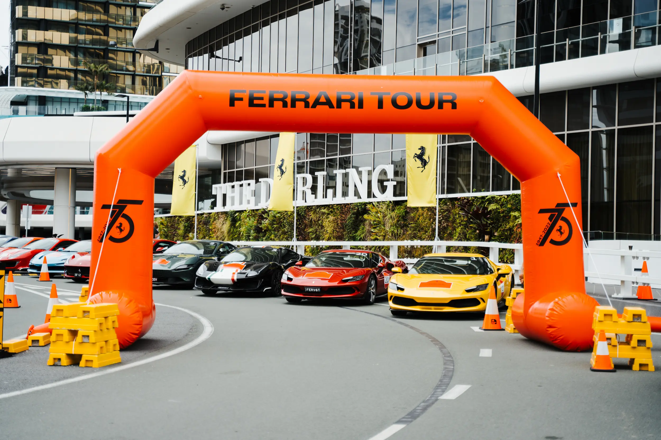 A group of cars parked in front of a building.