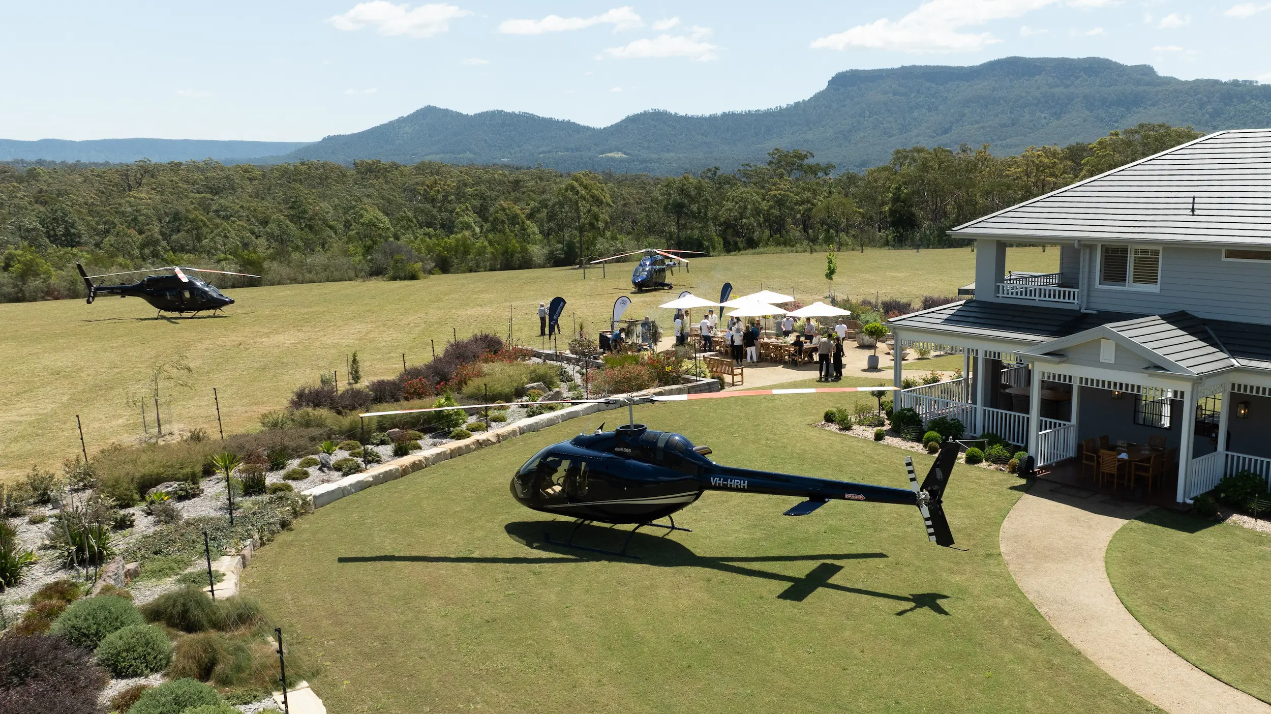 A helicopter is parked in front of a house.